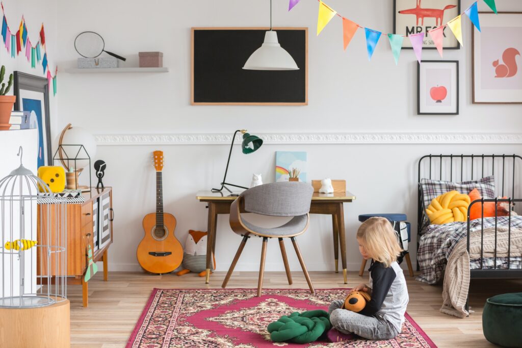 Little kid sitting on the rug in the white bedroom with vintage