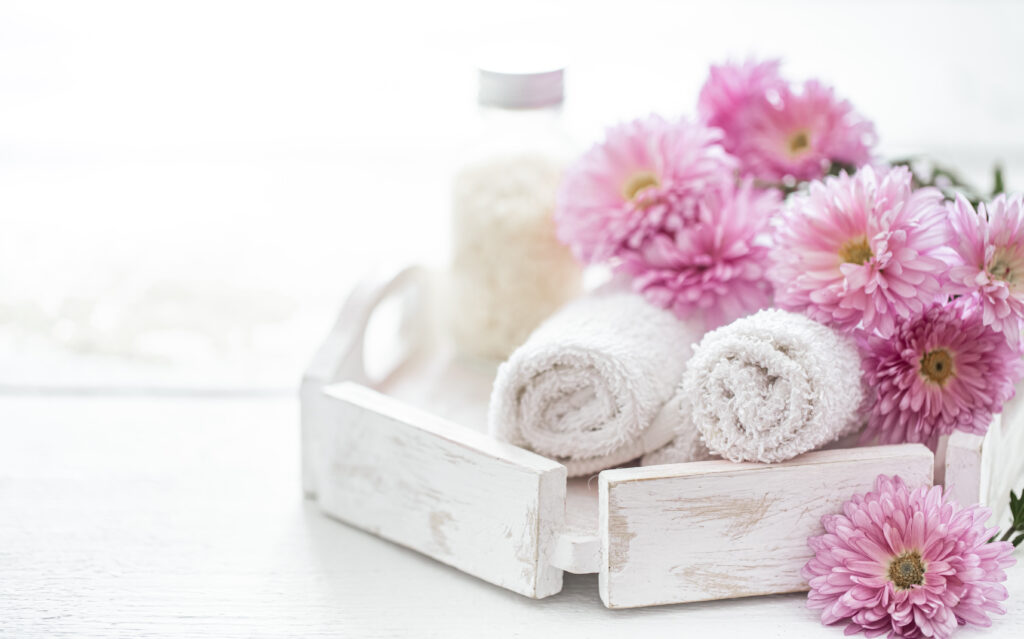 Spa composition with body care products and pink flowers. daily body care routine
