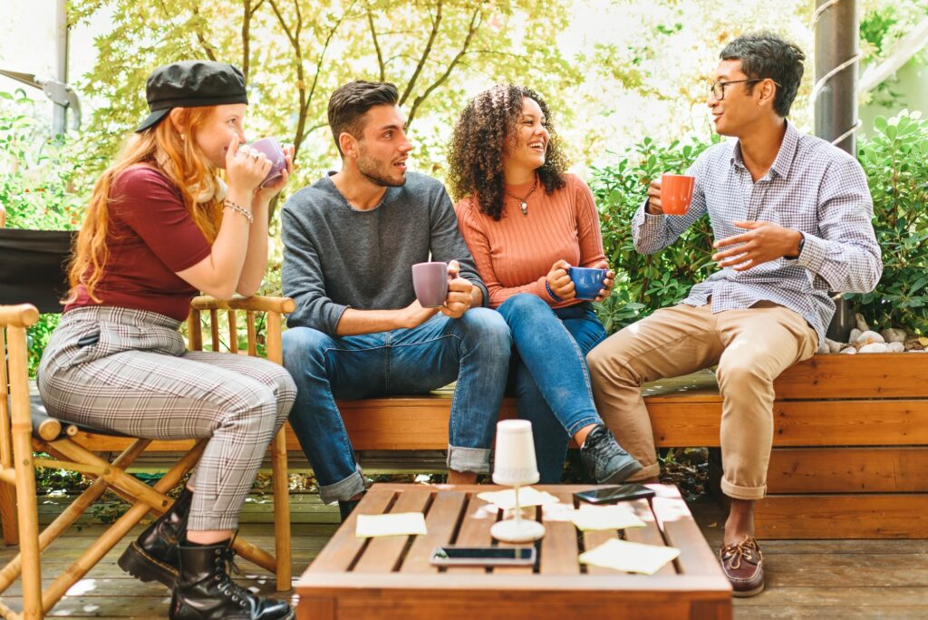 Group of multicultural young friends hanging out on a patio Balancing Work and Wellness