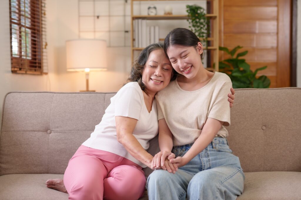 Mother-daughter Asian woman who spends her vacation in the living room happily and warmly expressing
