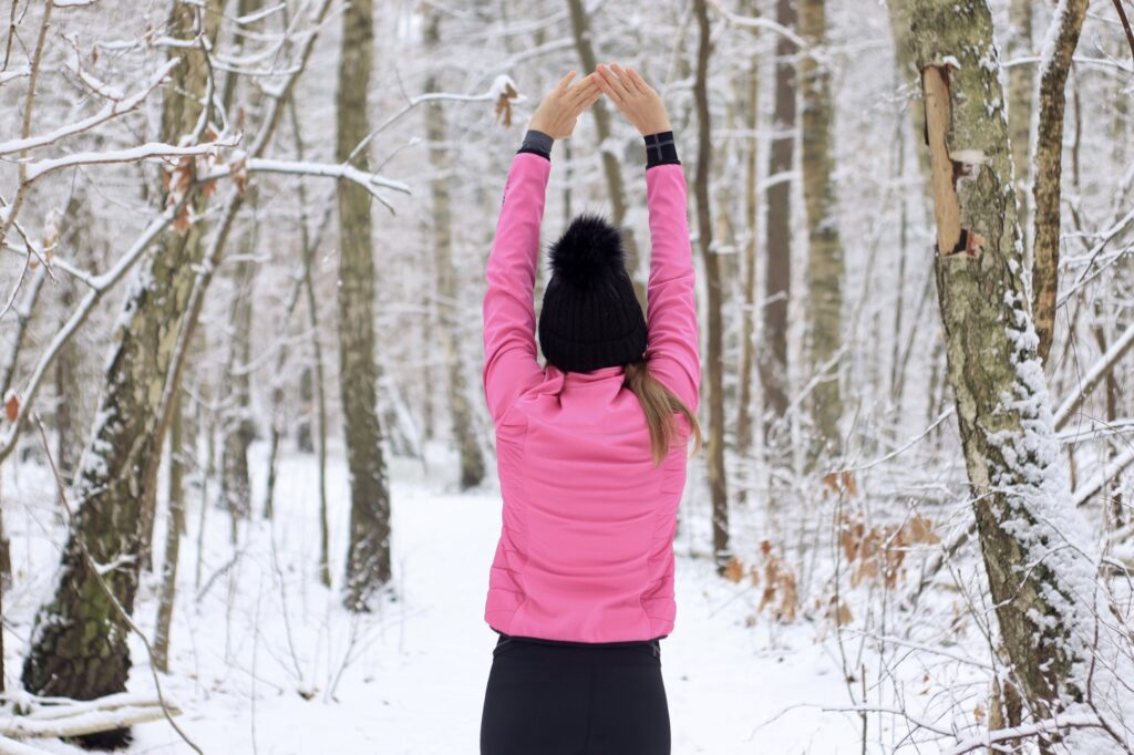 Young woman exercising outside in winter season , outdoor activities, healthy care, bodybuilding.