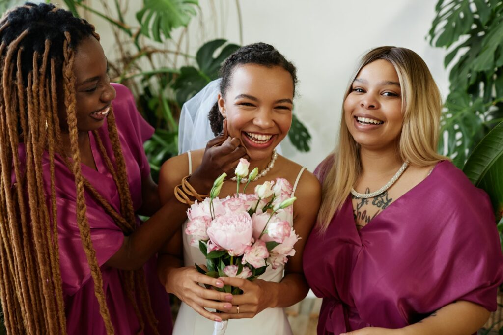 Young bride having fun with bridesmaids during wedding party