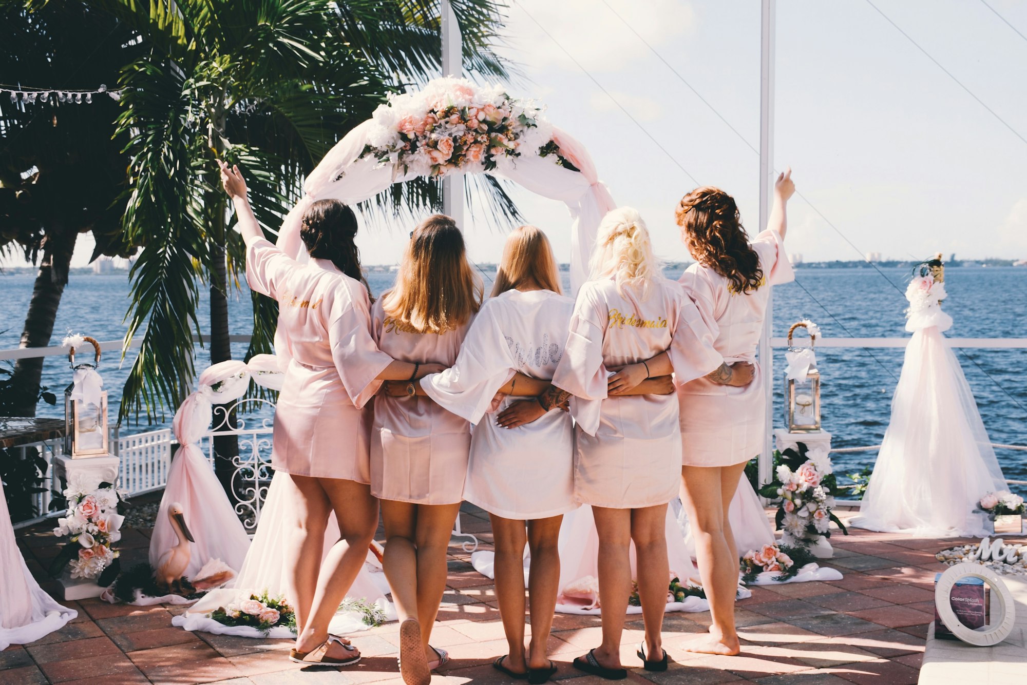 Bride surrounded by her girlfriends from behind