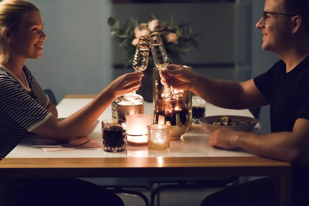 Couple enjoying romantic dinner at home At-Home Date Night Ideas for Couples