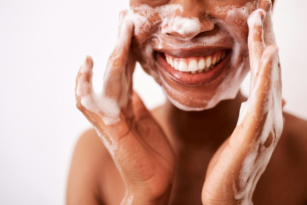 Studio shot of an unrecognizable woman washing her face against a white background DIY Facial at Home